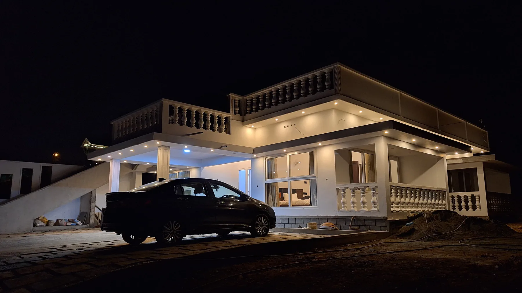 The villa lit up at night